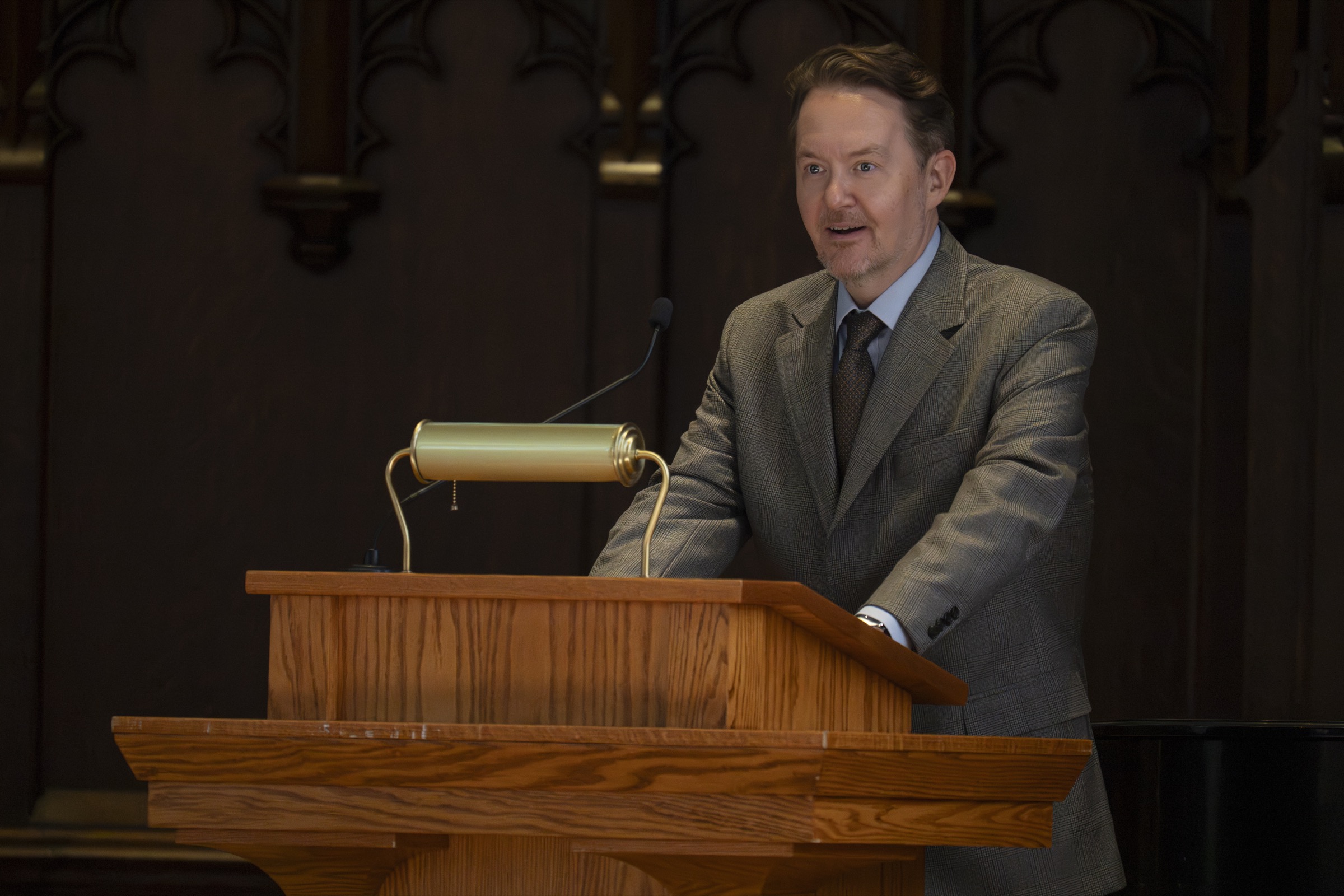 Andrew Reeves delivering remarks from a lectern at Washington University